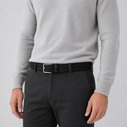 Person wearing a gray sweater and black pants with a mens belt